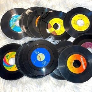 Set of 24 vinyl records. 45’s. Records only. A lot are scratched.